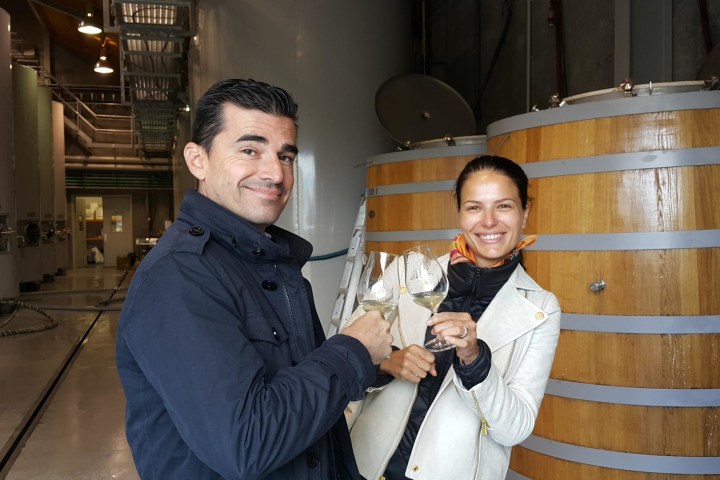 a man and a woman standing in front of a barrel