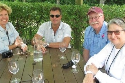 a group of people sitting at a table with wine glasses